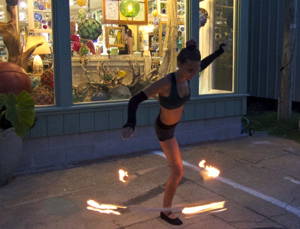Flaming hula hoop performance in front of Seagreen Gallery.