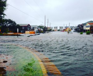 Hurricane flood damage in the outer banks with rising flood waters on a local street