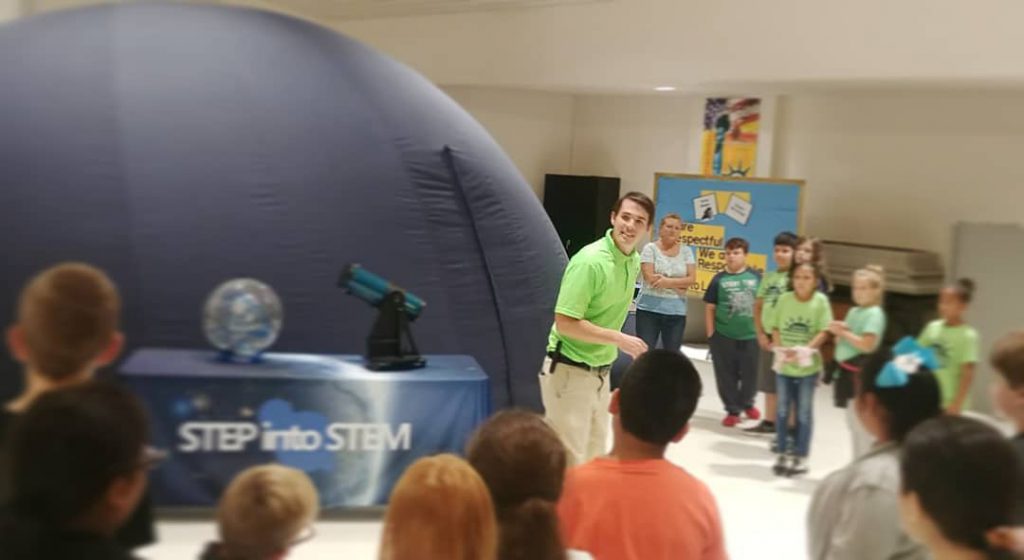Brian Baker, A Time for Science Astronomy and Space Science Director, showcasing the portable planetarium at a school outreach event. Photo Credit: A Time for Science