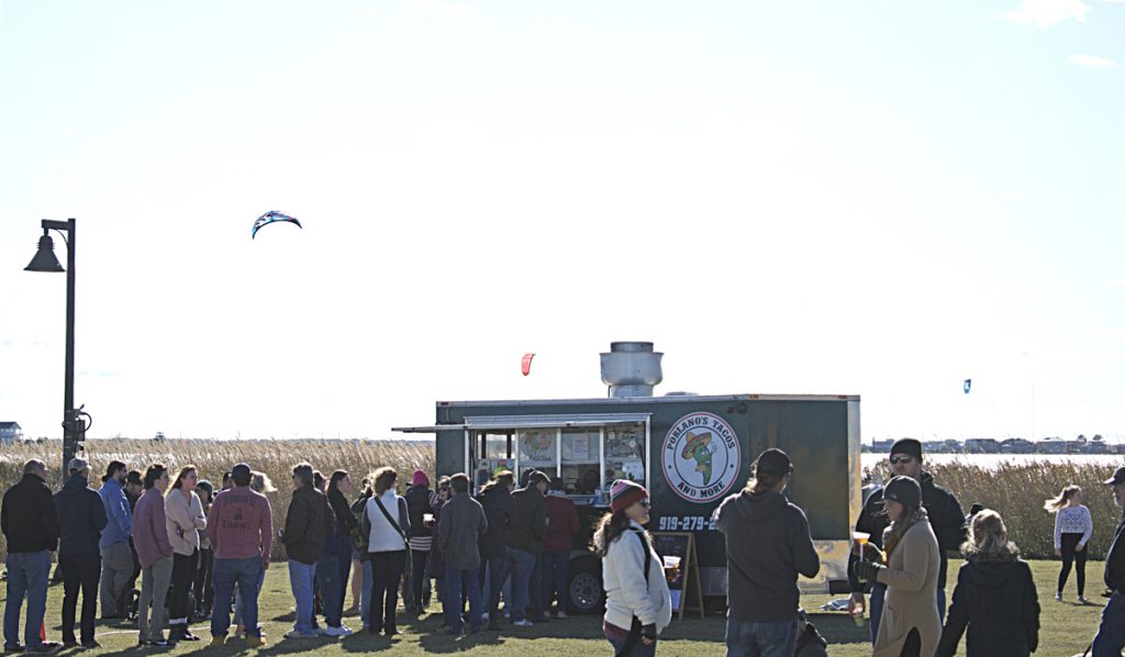 A good sized crowd for the Fall Food Truck Showdown at the Nags Head Event Site, and kiteboarders riding the wind on Roanoke Sound.