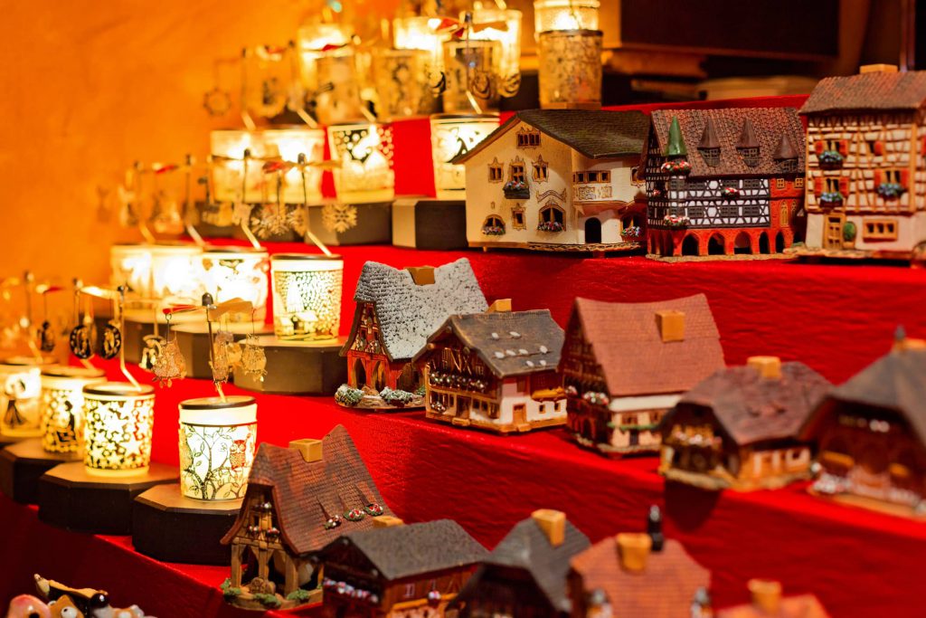 Shelves of Chritmas cottages and candles lit up.