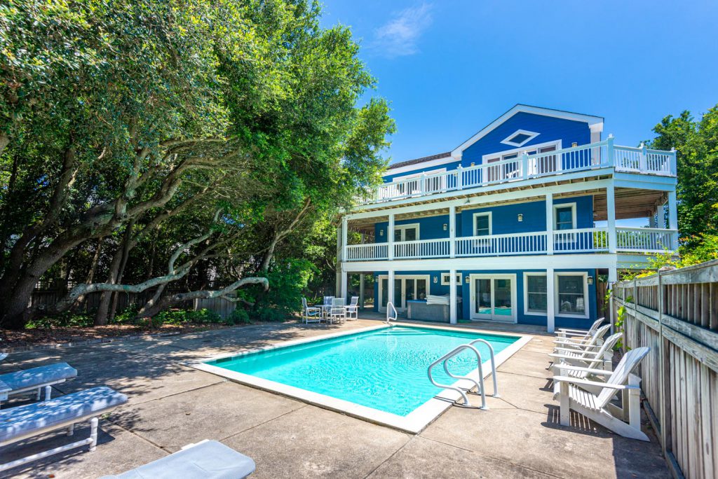 Three story blue vacation home on the Outer Banks of NC with a private pool.