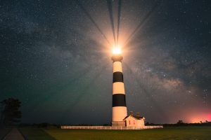 The lighthouse in the Outer Banks illuminating the night sky
