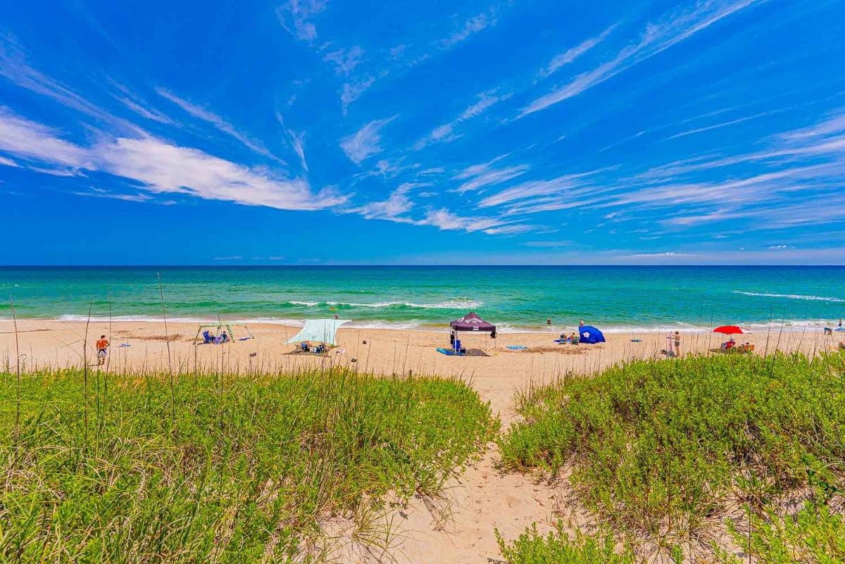 Sand path leading to beach canopies on the Outer Banks oceanfront.
